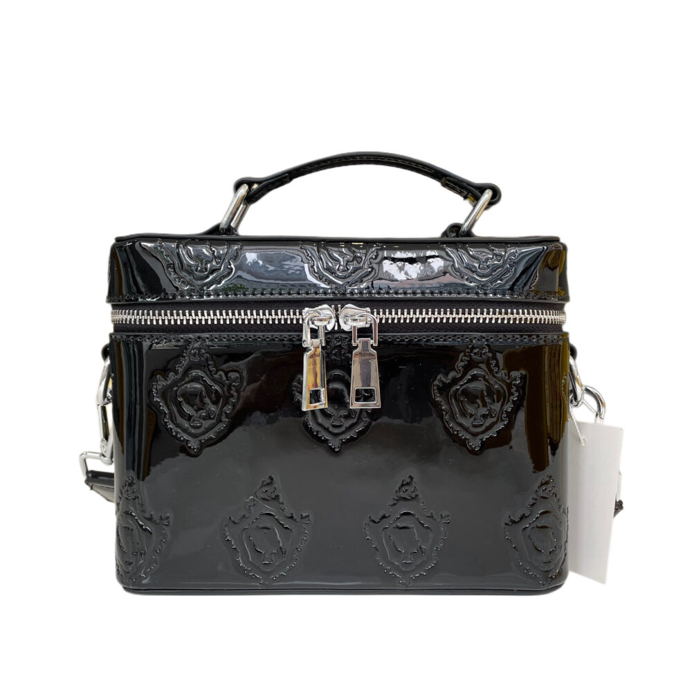 Black patent leather vanity bag with silver hardware, featuring a sleek strap for versatile use as a toiletry bag, cosmetic bag, or purse.