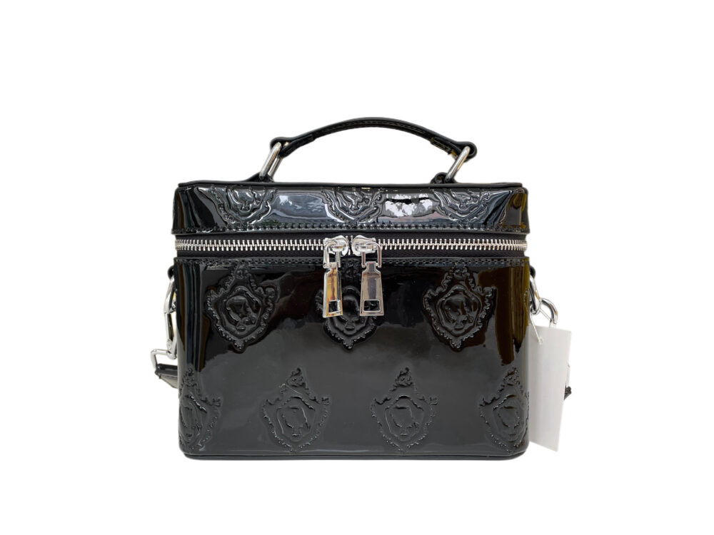 Black patent leather vanity bag with silver hardware, featuring a sleek strap for versatile use as a toiletry bag, cosmetic bag, or purse.
